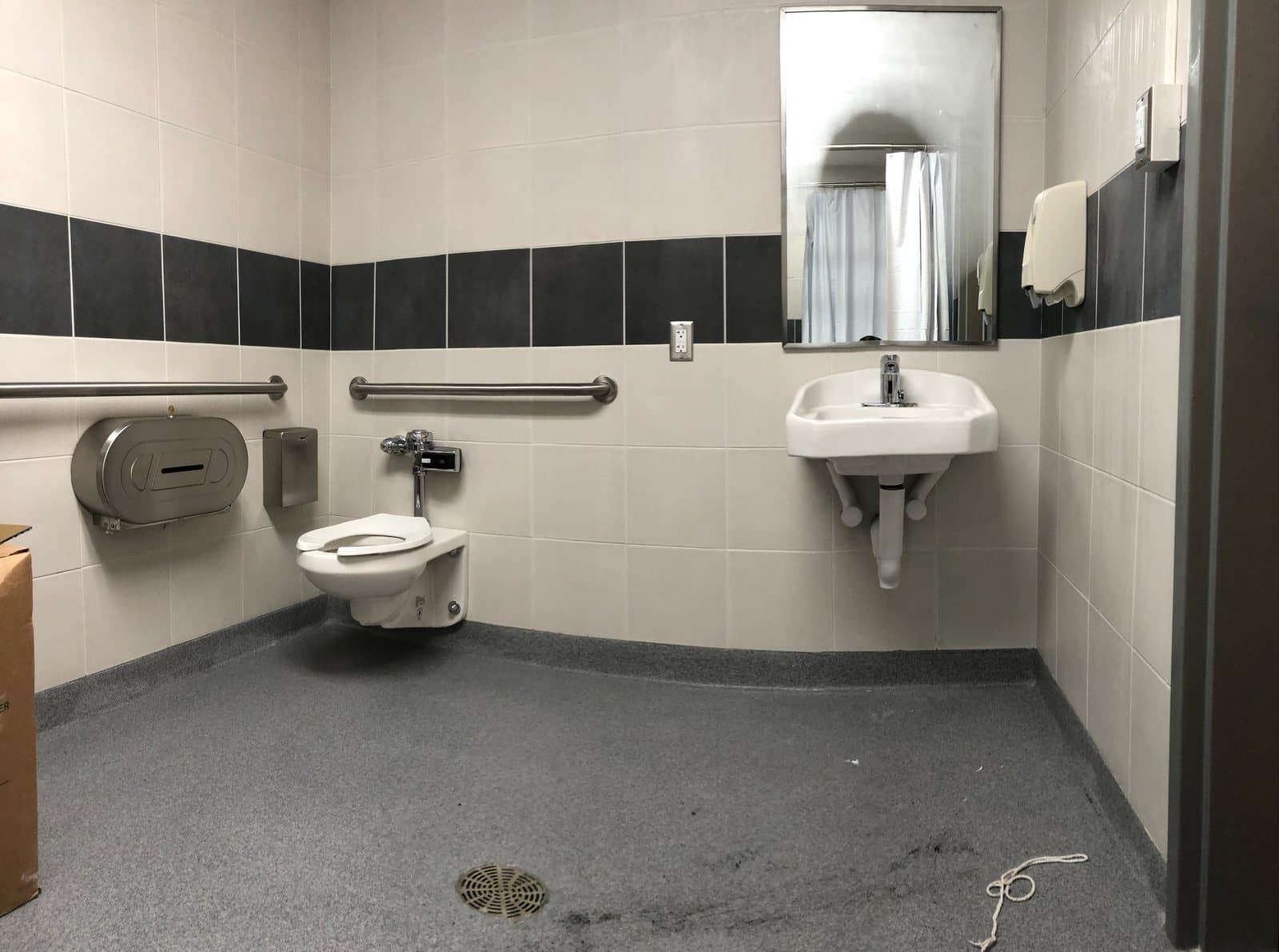 Accessible commercial restroom with toilet and grab bars