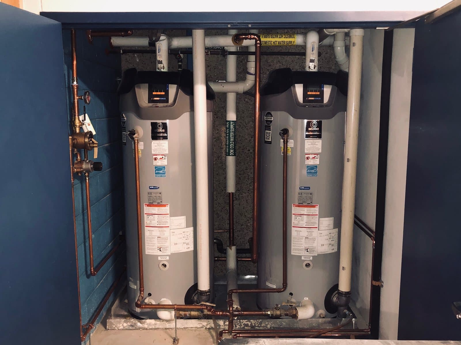 Dual tankless water heaters installed in a mechanical cabinet
