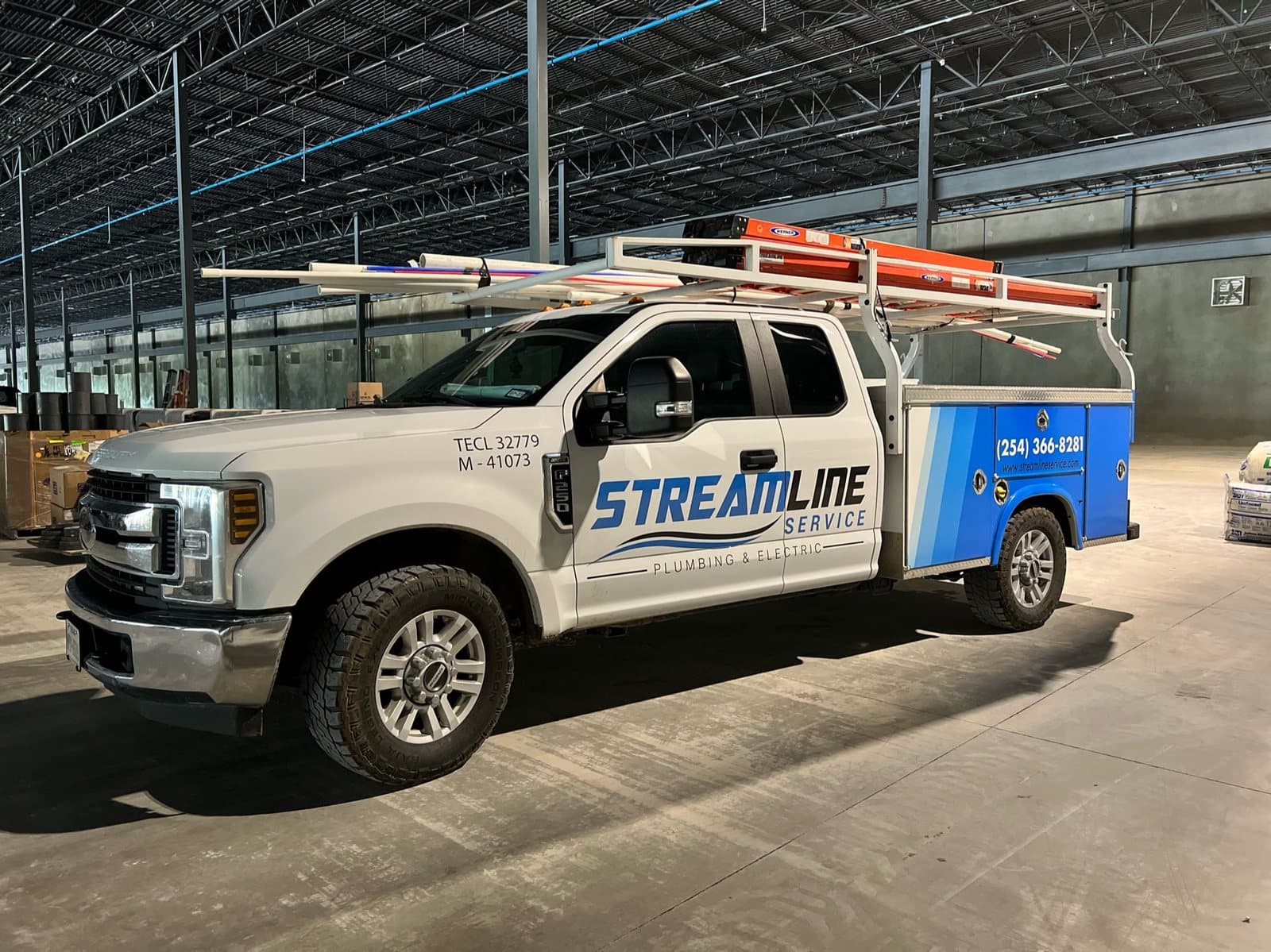 Streamline Service plumbing truck parked inside a large commercial project